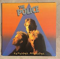 Front cover of The Police Zenyatta Mondatta vinyl LP showing band members with orange, purple background and stylized text.