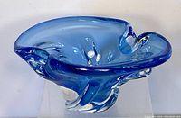 Side angled view emphasizing color and organic shape with rounded lobed edges and clear base.