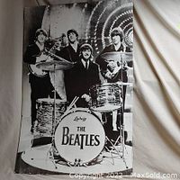 Large black and white poster of The Beatles with Ludwig drum and all four members