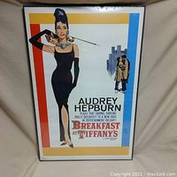 Framed poster of Audrey Hepburn in Breakfast at Tiffany's, still in protective plastic.