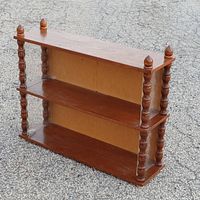 Front angled view of the wooden country shelf showing two shelves and four turned posts with finials