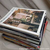 Stack of antique and collectors magazines with visible Architectural Digest on top