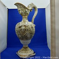 Full view of R Campodimonte vase showing sculpted female head and ornate body design with handle.
