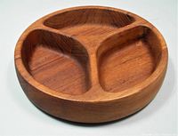 Top side view showing the three divided sections of the teak bowl with smooth rounded edges and rich wood grain.