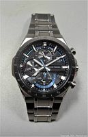 Front view of Casio Edifice watch showing the black dial with blue accents, three sub-dials, and stainless steel bracelet.