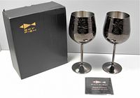 Two black baroque engraved stainless steel wine goblets with original box and user guide/manual.