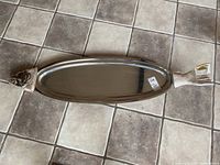 Top view of elongated stainless steel fish serving platter showing full length and polished surface.