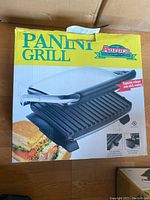 Box of Aurora panini grill showing product image and text
