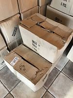 Stacked cardboard boxes labeled to contain 6 pieces each, marked fragile for glass items, showing the sealed shipping condition.