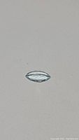 Top-down view of a marquis cut aquamarine gemstone showing clean, transparent light blue color.