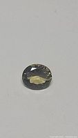 Oval faceted bi-coloured quartz showing smoky and lemon quartz colors.