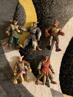 Top view of five mouse kangaroo anthropomorphic action figures in various colored outfits laid on a carpet.