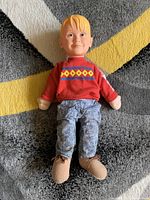 Front view of the Home Alone Kevin doll showing red sweater, blue pants, and molded plastic face and hands.