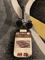 Mini burger basket and press with product label showing key features and branding.
