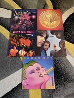 Top view of all 5 vinyl records showing covers with varied artwork and condition.
