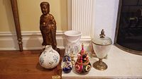 Full lot with decorative vases, wooden figurine, and small decorative objects