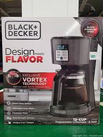 Boxed Black+Decker 12-cup programmable coffee maker with product image and features listed on box.