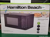 Photo of the product box showing the Hamilton Beach microwave oven details and image.
