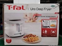 Front view of the original packaging box for the T-fal Uno deep fryer showing features and branding