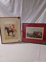 Both framed vintage British military prints positioned side by side, one portrait-oriented and the other landscape-oriented showing Wellington and Grenadiers respectively.