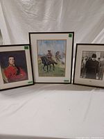 Frontal view of all three framed prints showing subjects and frame/gilt details