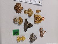 Photo showing nine assorted Canadian military and RCMP metal badges of various types and designs.
