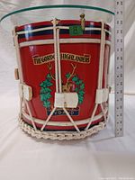 Front view of red wood drum featuring The Gordon Highlanders crest and braided rope detailing.
