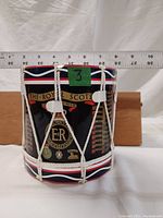 Plastic ice bucket with Royal Scots badge and battle honors, shown with a ruler for size reference indicating about 6 inches tall.