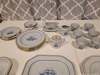 Overview of all pieces laid out: plates, cups, serving pieces, platters
