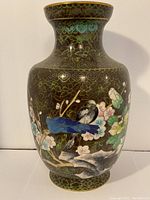 Full front view of the cloisonné vase showing the two birds perched on a branch with floral background and gold accents on dark background.