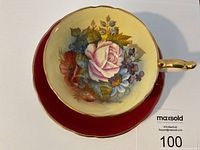 Top-down view of teacup seated on saucer showing full interior floral pattern and saucer color.