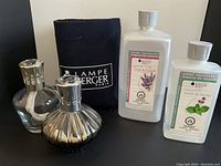 Overview of both lamps, refill bottles, and pouch.
