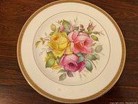 Full view of the 10 inch diameter cabinet plate showing the entire floral design and gold rim detailing.