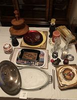 Lot arranged on table showing candlestick holders, candles, trays, and buffet dish.