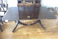 Full top view of the two-tone wood dining table showing metal detail on legs and feet.