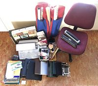 Full overview of the office chair, typewriter, binders, paper supplies including envelopes, writing tools, hole punches, rulers, and wrapping paper rolls.