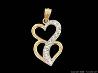 Front view of double heart pendant showing gold and diamond accented design.