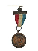 Full medal including tricolor ribbon and original pin with crown detail from the rear side.