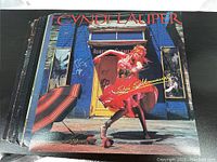 Photo of 7 of the 8 LP record covers showing the front with some wear visible; includes Cyndi Lauper She's So Unusual as the top album cover