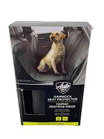 Product packaging showing the hammock seat protector installed in a vehicle back seat with a dog sitting on it.