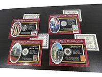 Four cardboard sleeves displaying Canada's historic coins and matching stamps. Certificates of Authenticity visible behind the sleeves.