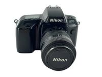 Front view of Nikon F70 film camera with 35-105mm Nikkor lens attached, Nikon branded lens cap visible