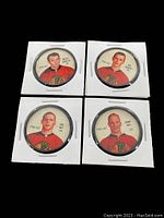 Four vintage Chicago Black Hawks hockey coins in white holders showing players Horvath, Murphy, Hull, and Hay