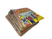 Stack of 27 vintage 1980s Archie comic books with the top one being an Archie’s Pals ’n’ Gals issue, showing colorful cover art and visible spine wear consistent with age.