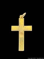Front view of flat yellow gold cross pendant showing smooth rectangular arms and surface wear.
