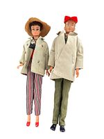 Full length photo of Barbie and Ken dolls side by side in their outfits.