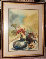 Frontal photo of the framed watercolor still life painting by Annamaria Zettlemoyer showing the composition of pear, eggplant, onion, and autumn leaves.