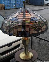 Angled front view showing stained glass shade pattern and brass-tone base.