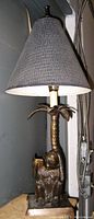 Full lamp view with bronzed monkey and palm tree base, conical dark textured lampshade, showing lamp shape and detailing