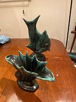 Fish-shaped pottery vase showing sculptural form and glaze